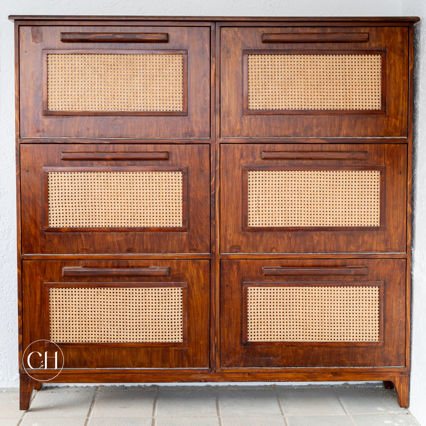 CustHum - Front view of large wooden shoe rack with six compartments; the cabinet has rattan on panel and wooden handles