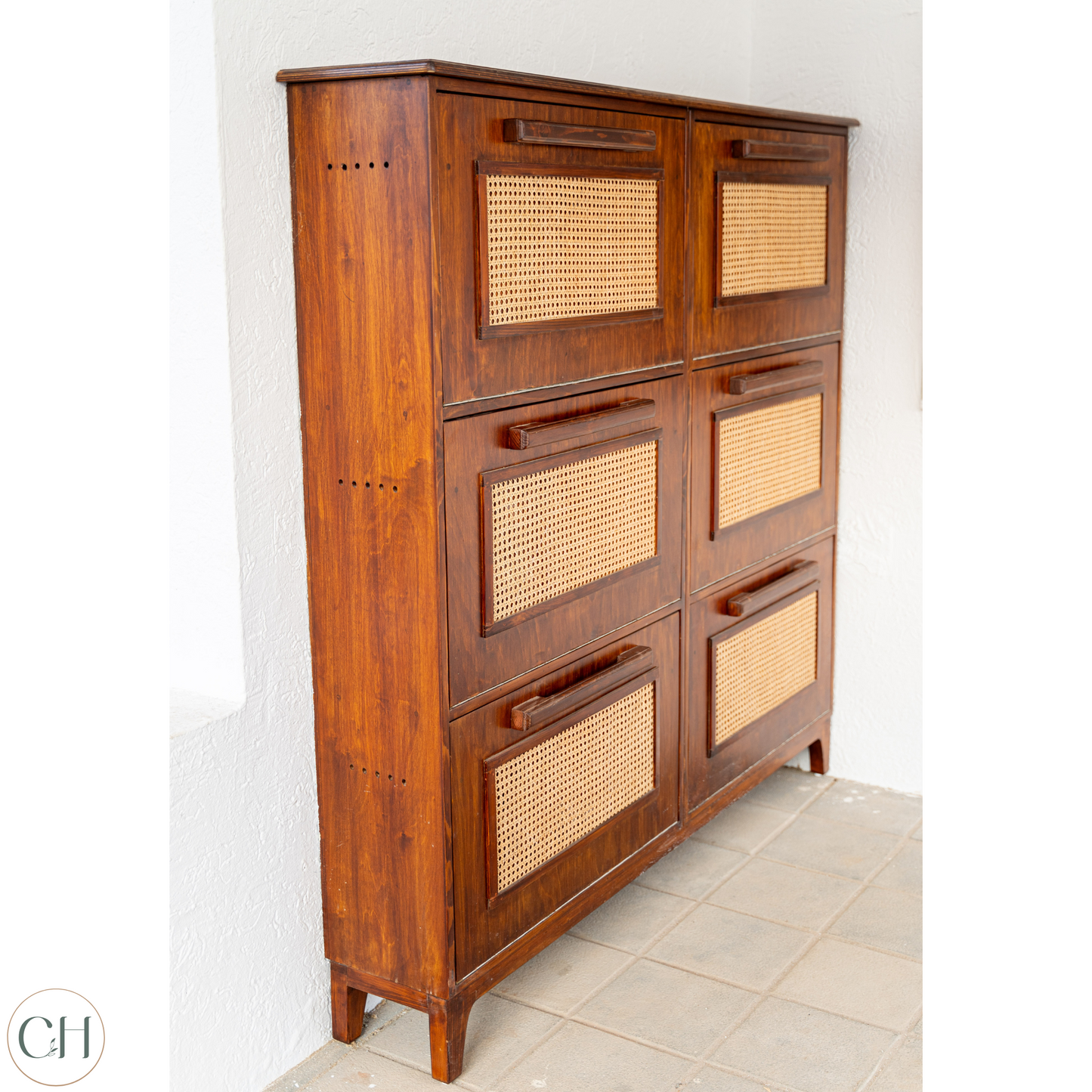 CustHum - ISO view of large wooden shoe rack with six compartments; the cabinet has rattan on panel and wooden handles