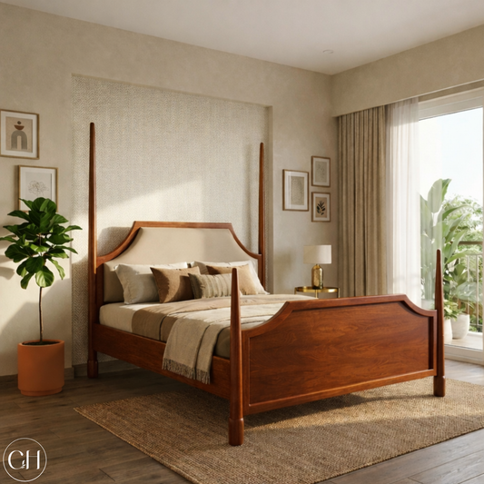 CustHum four-poster bed in teak wood tone, shown in a bedroom with a plant and framed pictures on the wall.