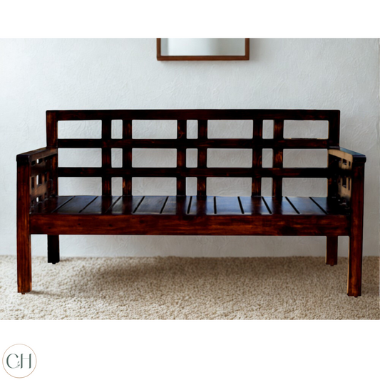 Wooden bench with lattice backrest design against a plain wall background