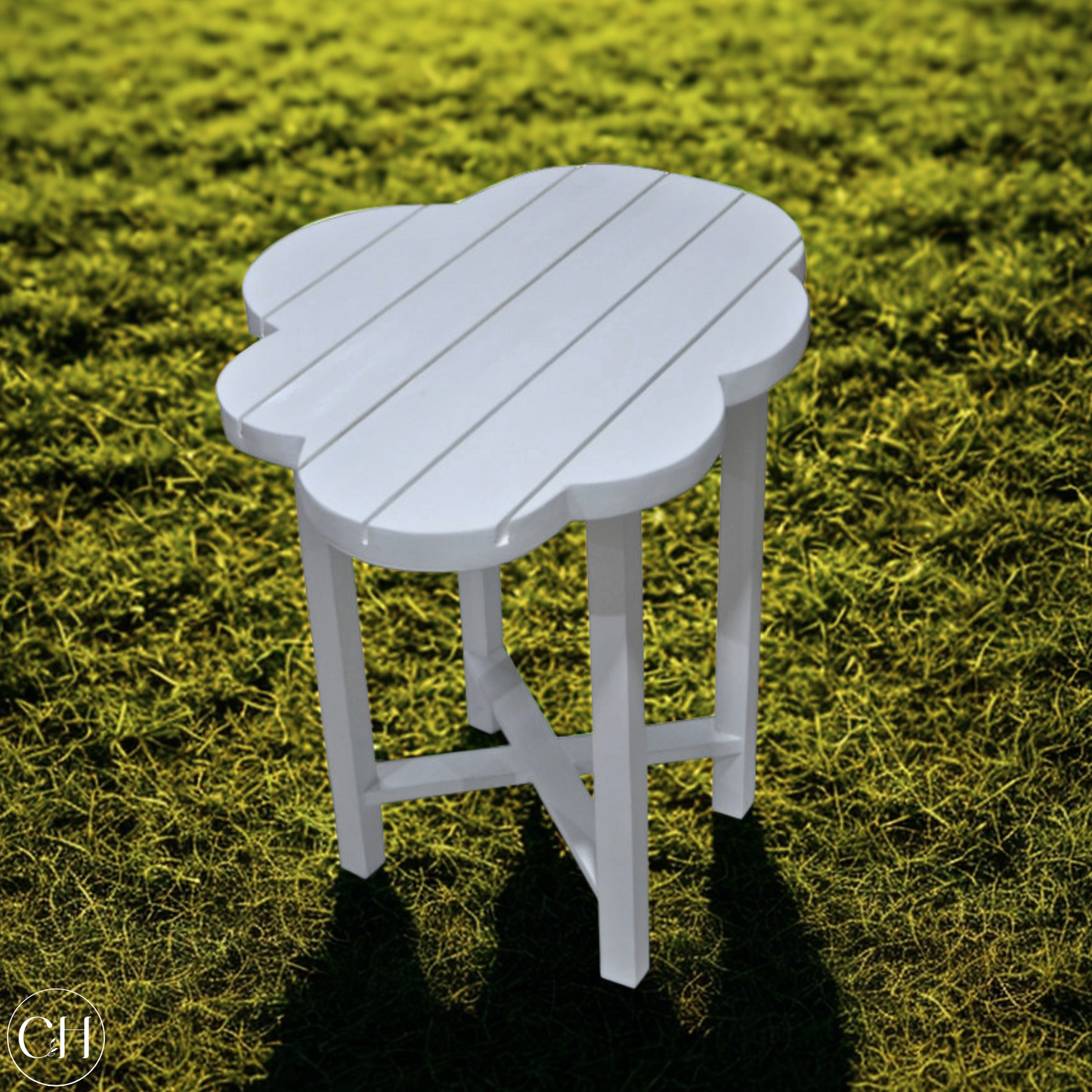 White outdoor stool with cloud-shaped top, set on a grassy background